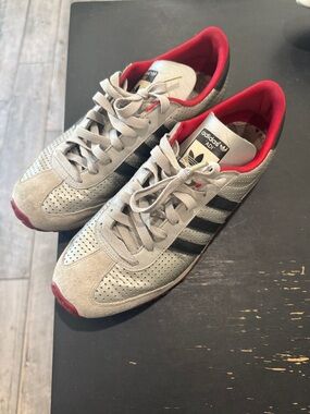 adidas gray sneakers with black stripes and red lining